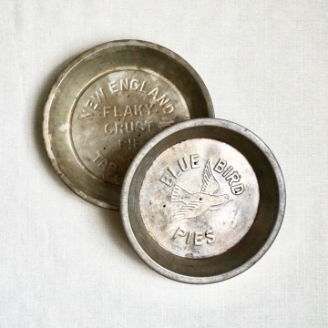 Two Vintage 9" Pie Tins Blue Bird & New England Table Talk